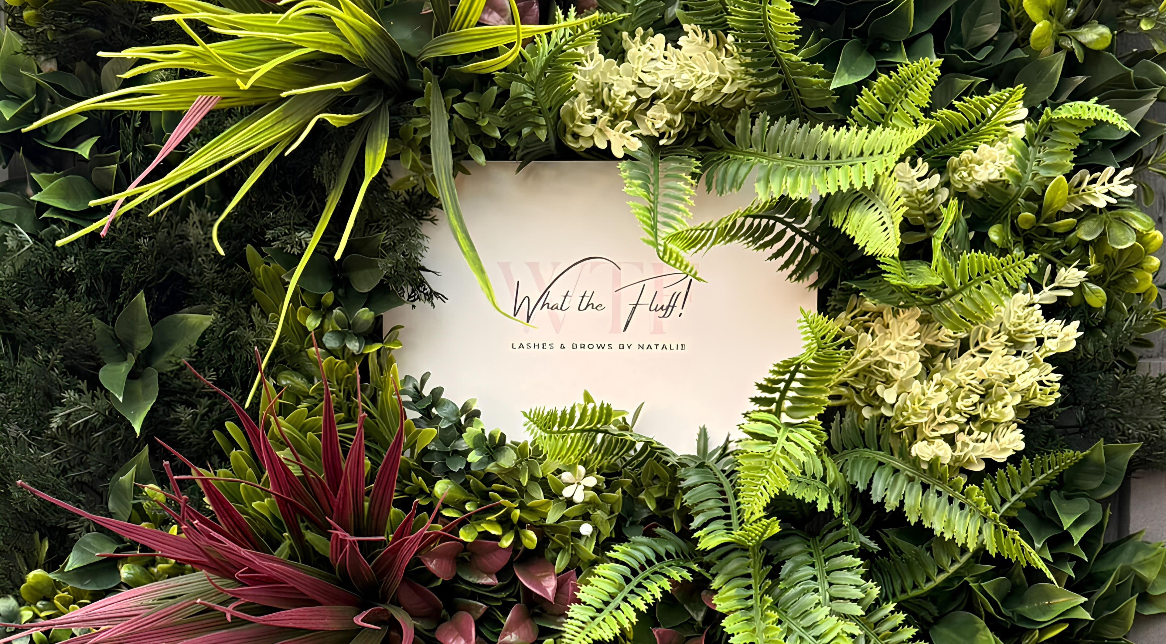 Floral display with 'What the Fluff! Lashes & Brows' sign in Nottingham, England, GB.