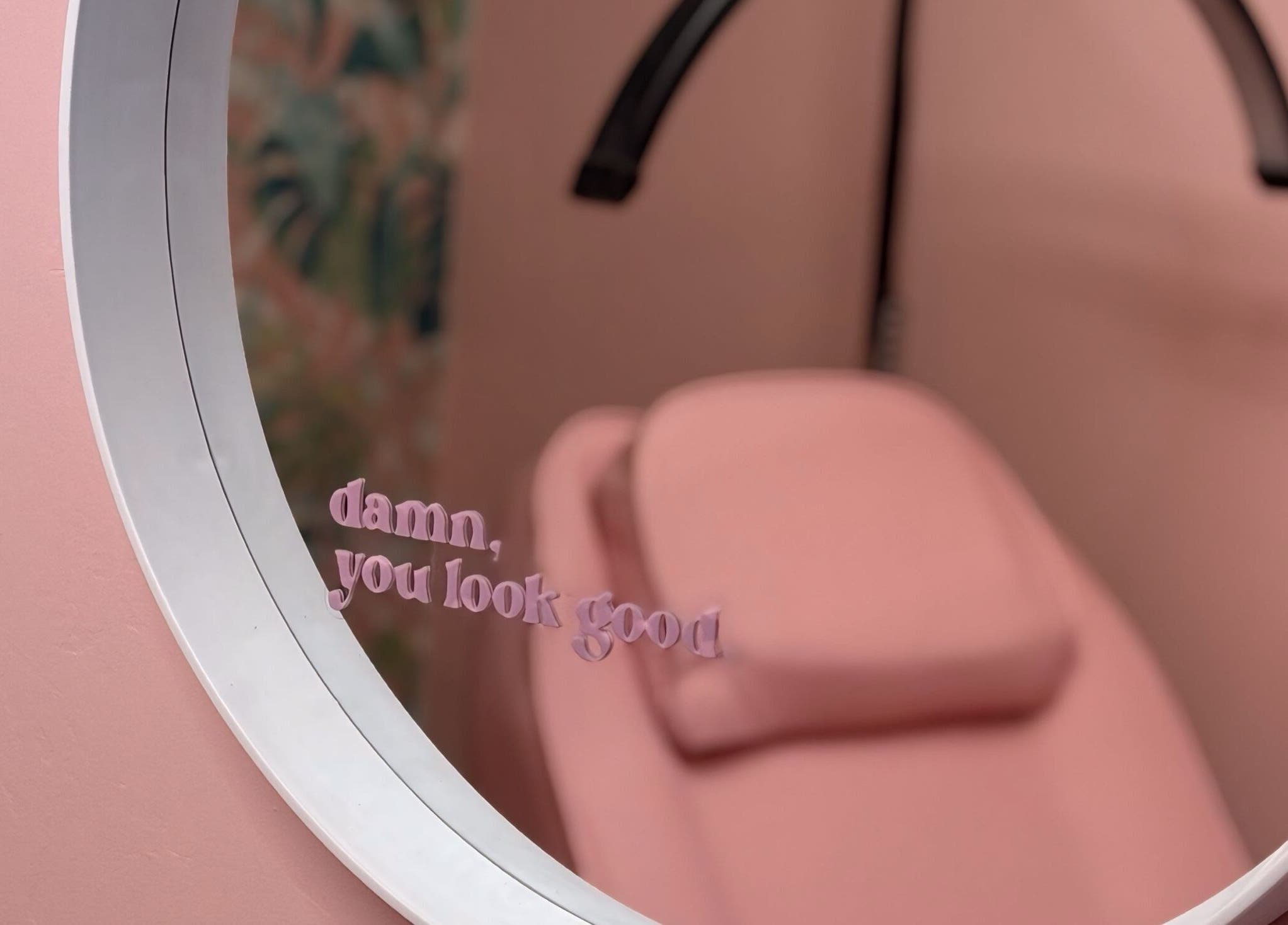 Stylish pink therapy room at What the Fluff! Lashes & Brows in Nottingham, England, GB with a motivational mirror quote.