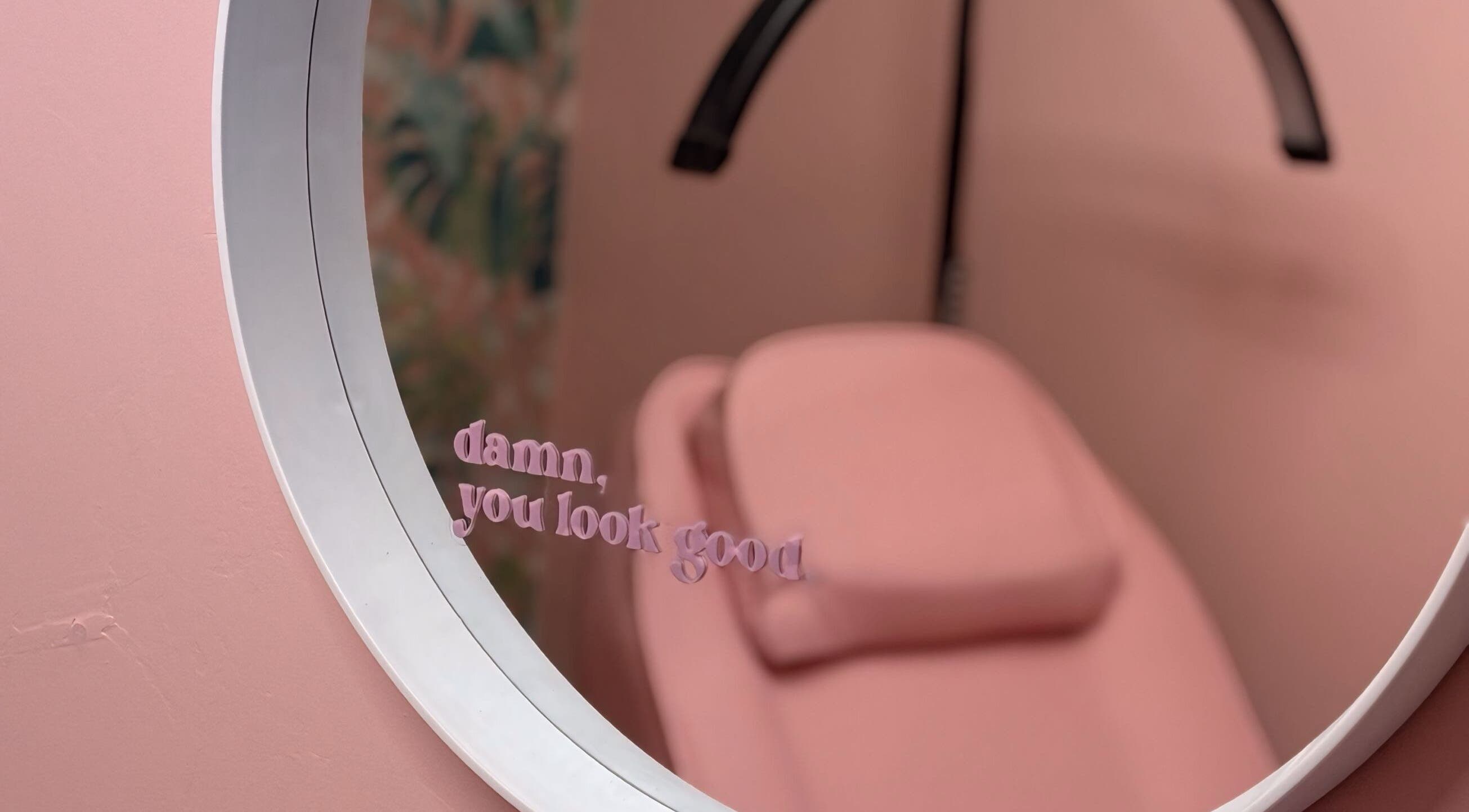 Stylish pink therapy room at What the Fluff! Lashes & Brows in Nottingham, England, GB with a motivational mirror quote.