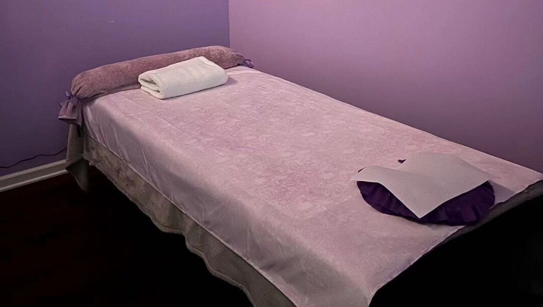 Relaxing massage table at AA Foot & Body Spa, Lisle, Illinois, US with soft purple tones.