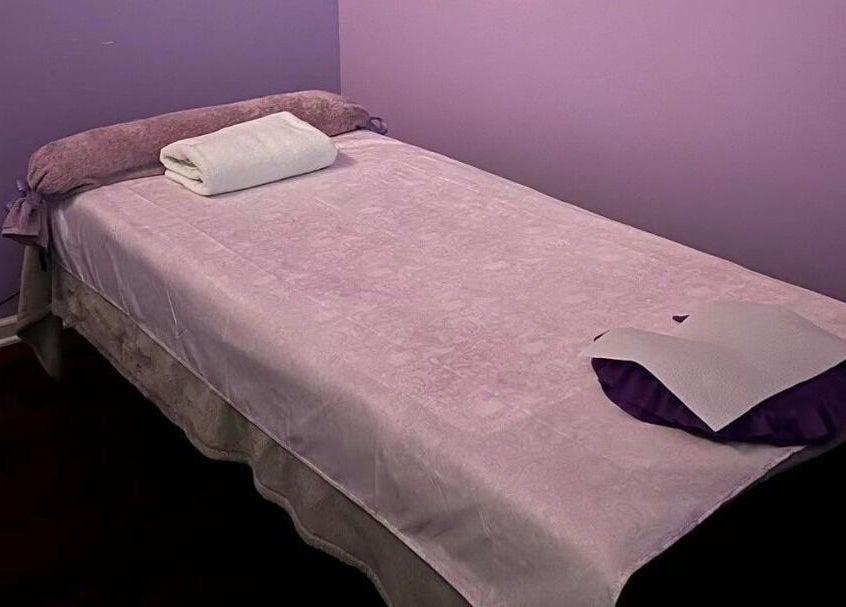 Relaxing massage table at AA Foot & Body Spa, Lisle, Illinois, US with soft purple tones.