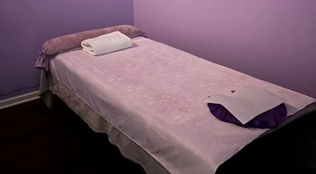 Relaxing massage table at AA Foot & Body Spa, Lisle, Illinois, US with soft purple tones.
