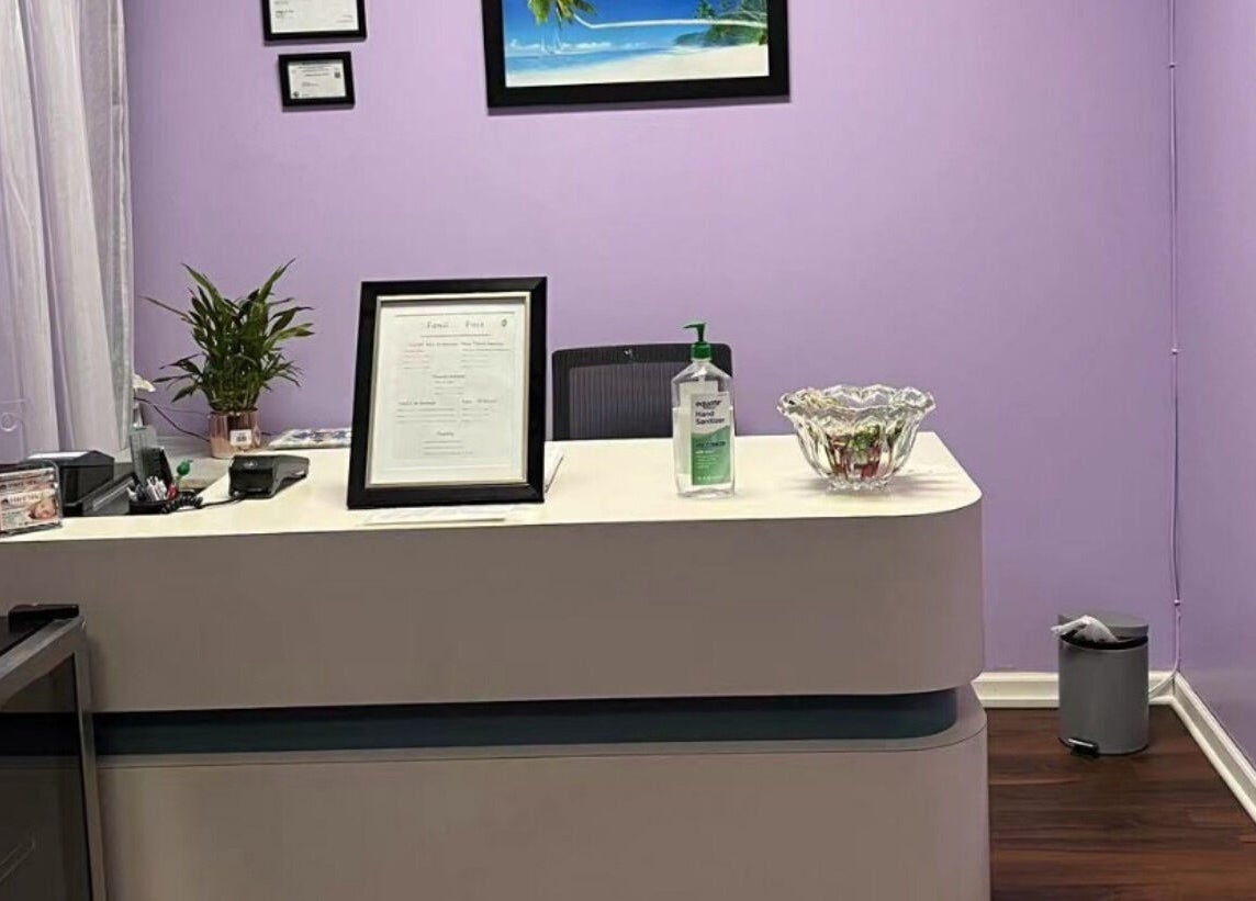 Reception desk at AA Foot & Body Spa in Lisle, Illinois, US with purple walls and decor.