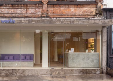 Inviting facade of Muscle Works in Bali, ID, showcasing a modern glass entrance with minimalist decor.