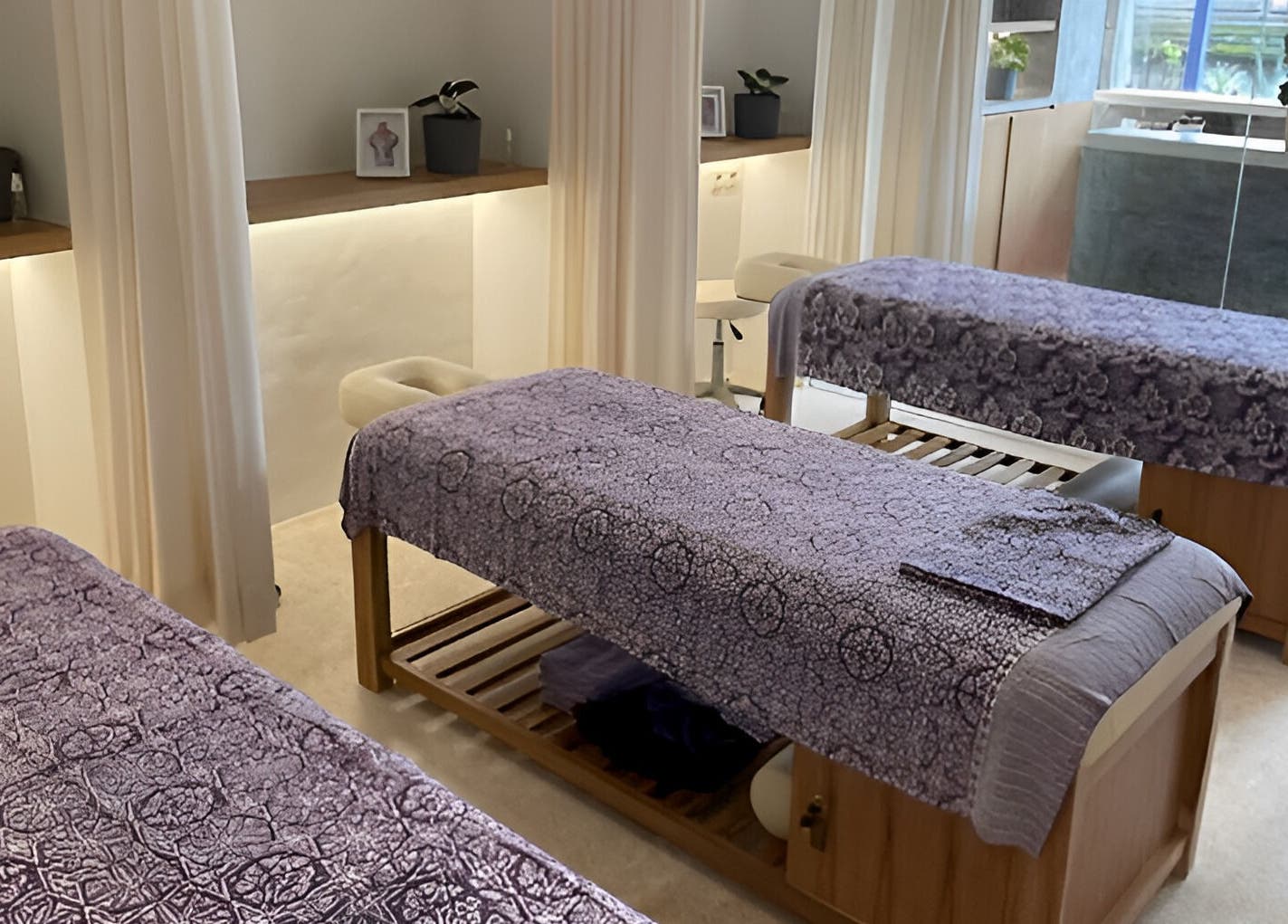 Serene massage room at Muscle Works, Bali, Bali, ID with comfortable tables and soothing decor.