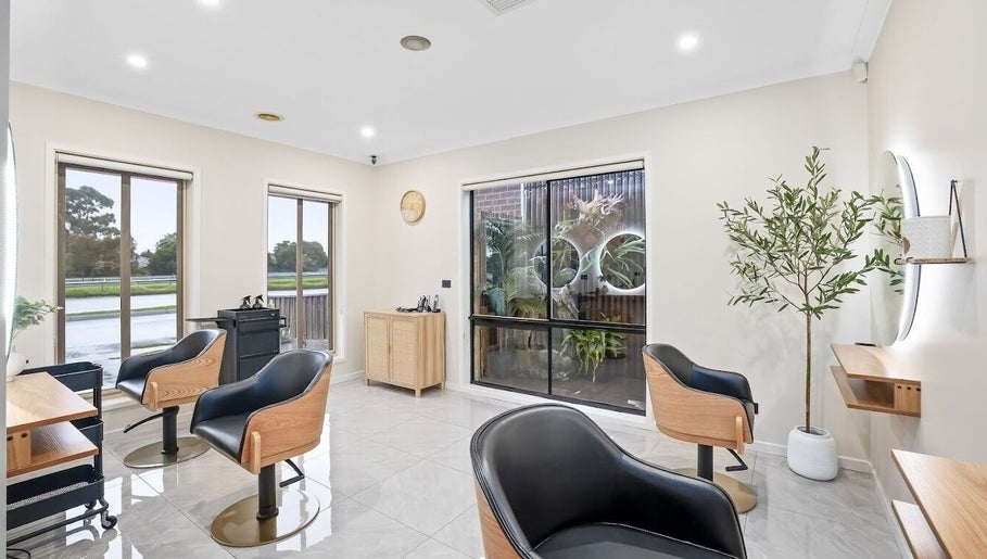 Modern salon interior at Yasu's Salon, Melbourne, Victoria, AU with trendy chairs and natural light.