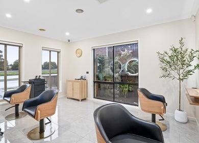 Modern salon interior at Yasu's Salon, Melbourne, Victoria, AU with trendy chairs and natural light.