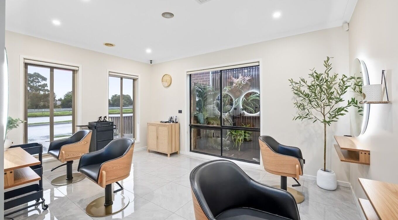Modern salon interior at Yasu's Salon, Melbourne, Victoria, AU with trendy chairs and natural light.