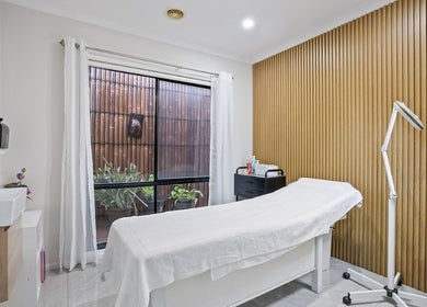 Relaxing spa room at Yasu's Salon, Melbourne, Victoria, AU, featuring a treatment bed and modern decor.