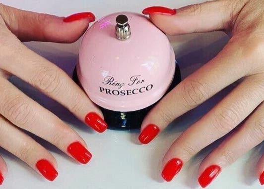 Bright red nails with a pink bell at You and Me - Nails by Dom, London, England, GB.