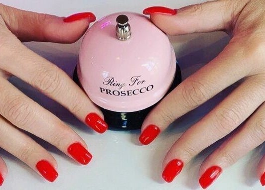 Bright red nails with a pink bell at You and Me - Nails by Dom, London, England, GB.