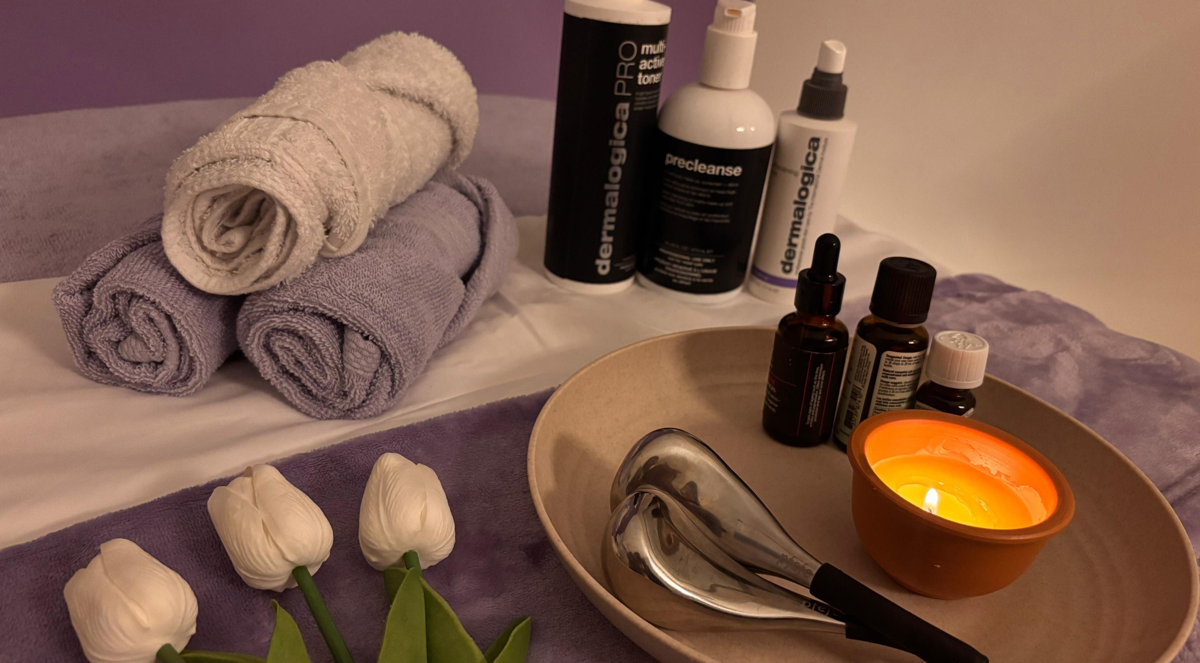 Relaxing spa setup with towels and candles at QST Esthetics - Facials and Massage, Ottawa, Ontario, CA.