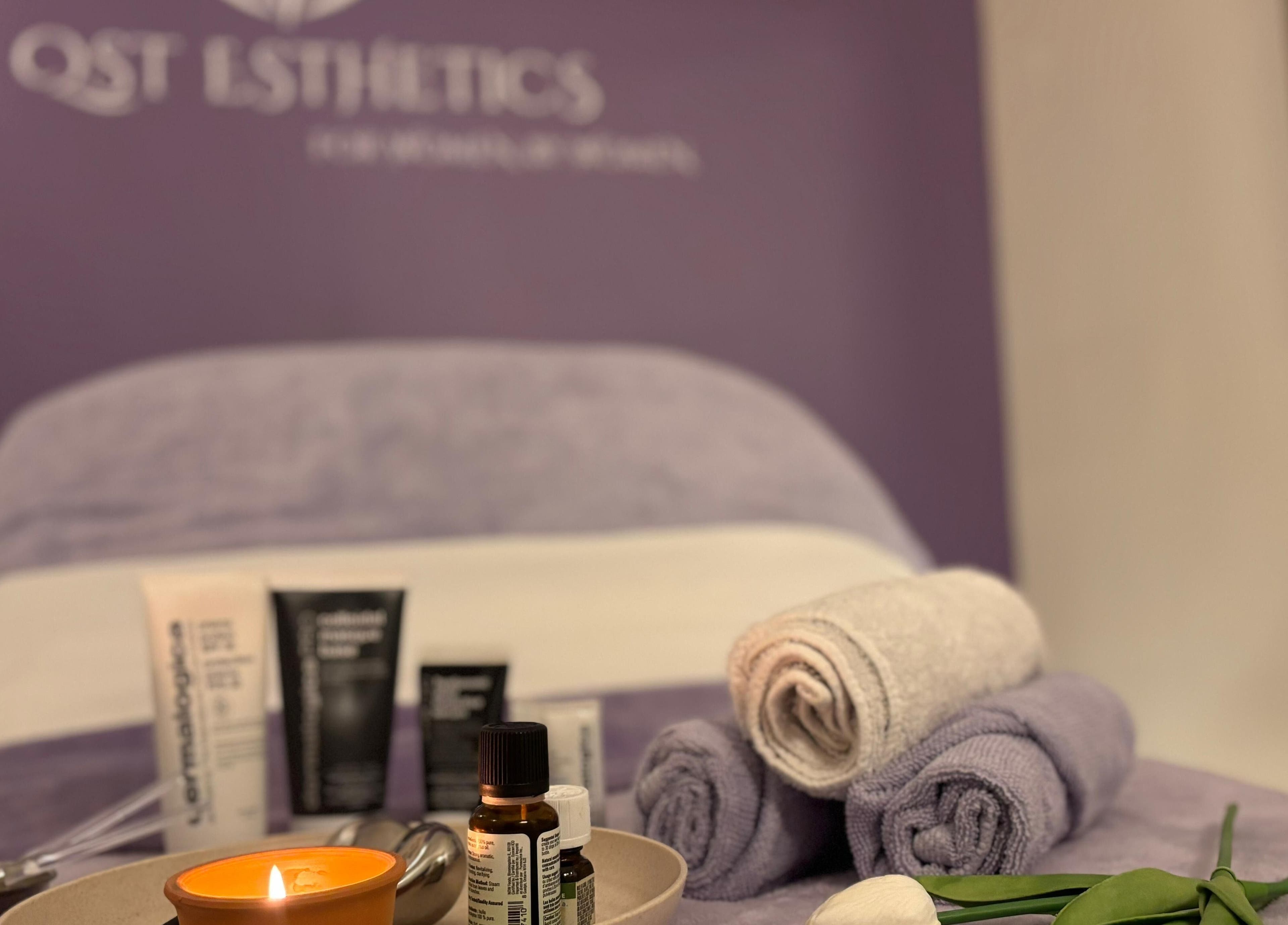 Luxurious spa setup at QST Esthetics - Facials and Massage in Ottawa, Ontario, CA with oils and towels.