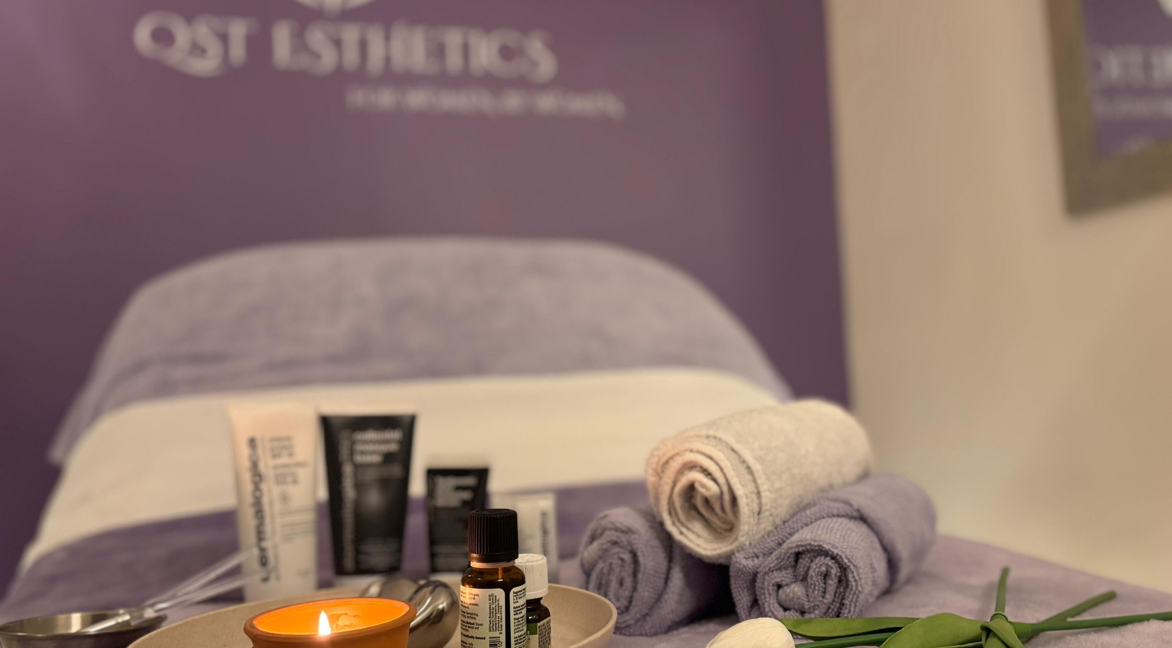 Luxurious spa setup at QST Esthetics - Facials and Massage in Ottawa, Ontario, CA with oils and towels.