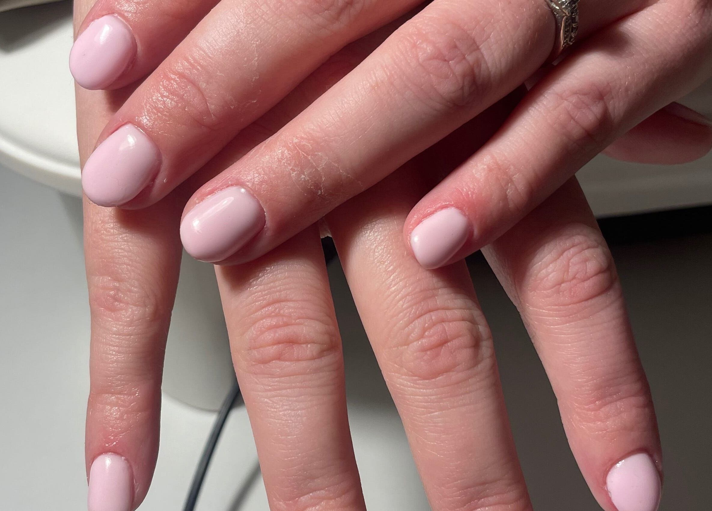 Beautifully manicured nails at HLM Nails in Charfield, England, GB showcasing soft, pastel pink finish.