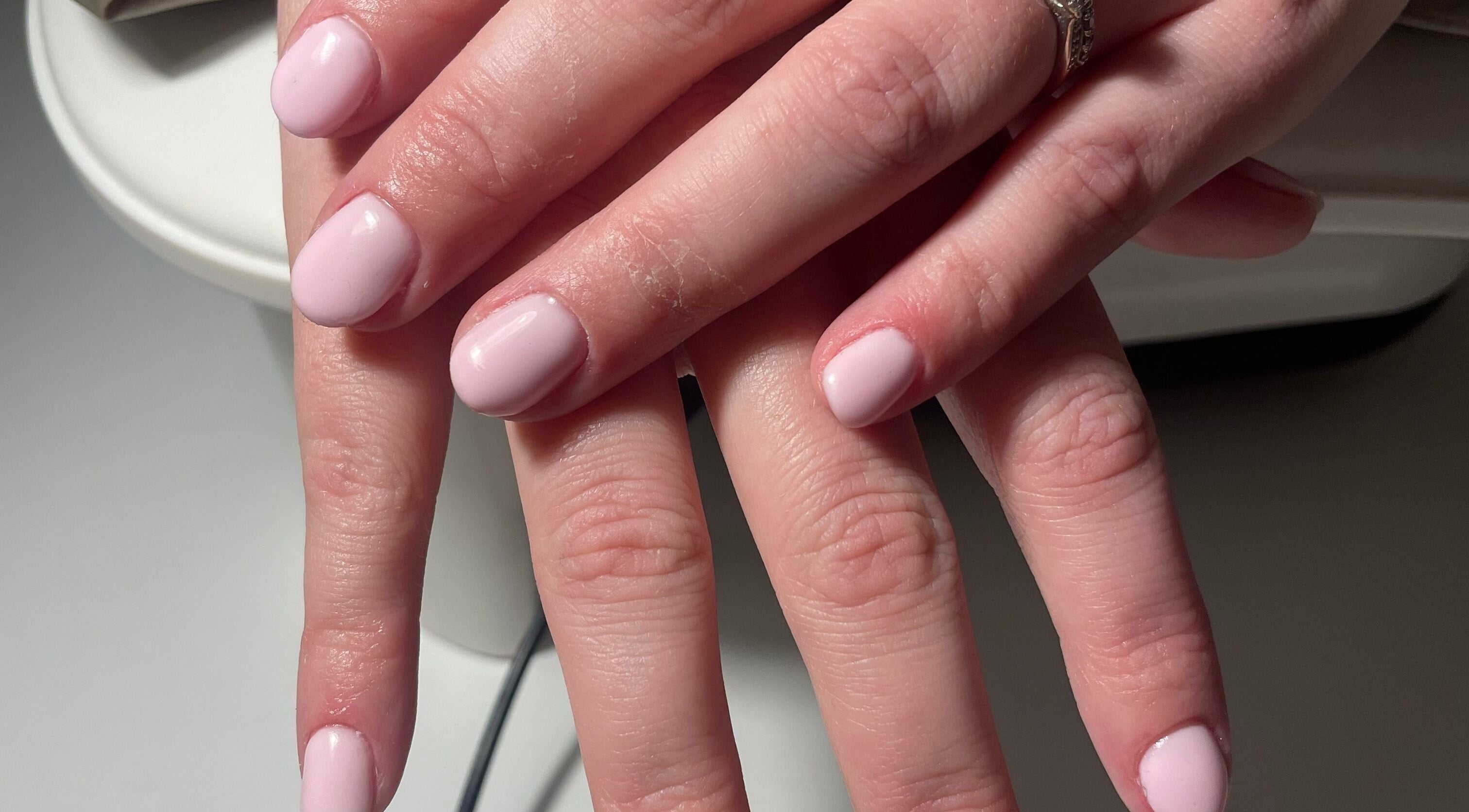 Beautifully manicured nails at HLM Nails in Charfield, England, GB showcasing soft, pastel pink finish.