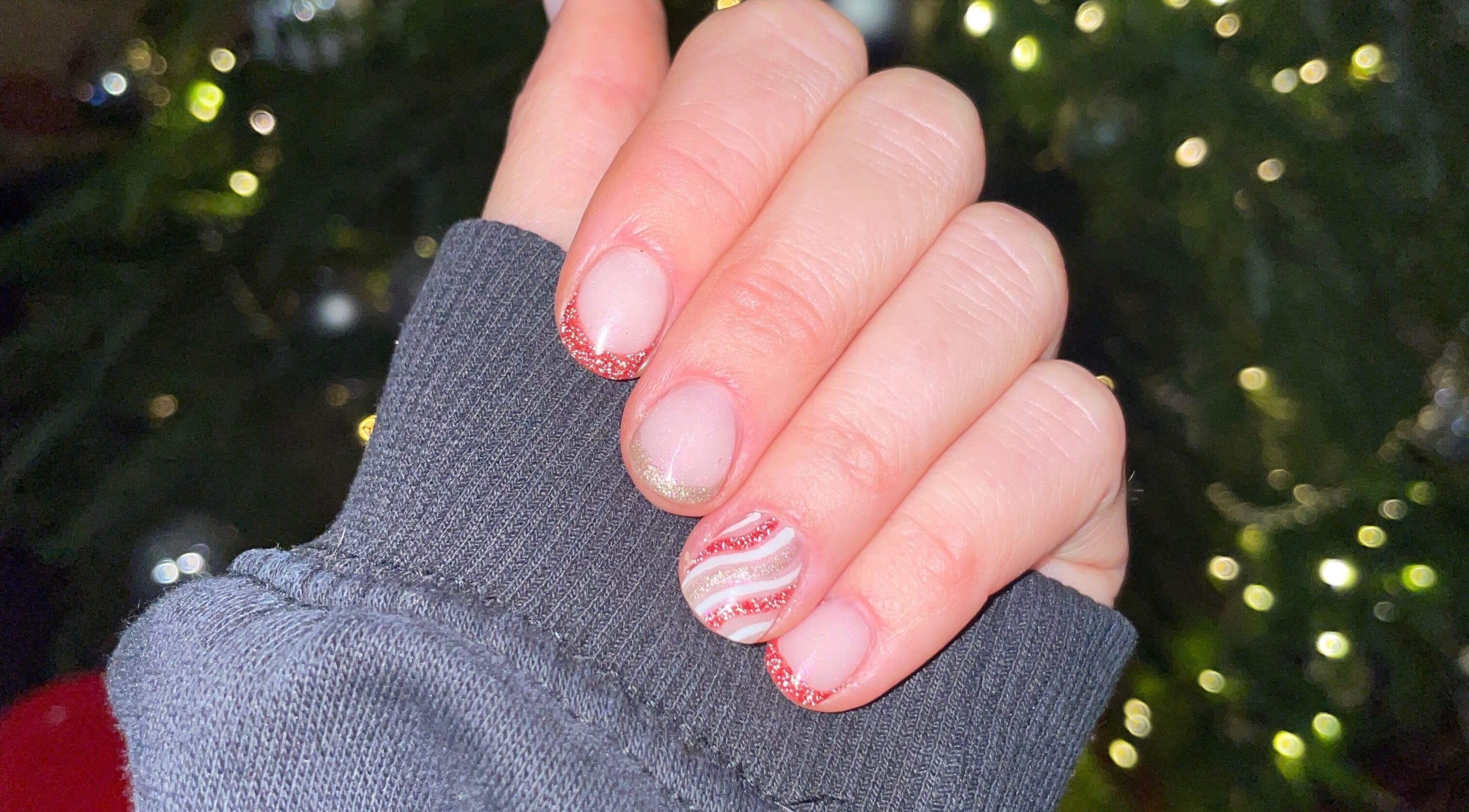Festive nail art with red glitter tips at HLM Nails, Charfield, England, GB.
