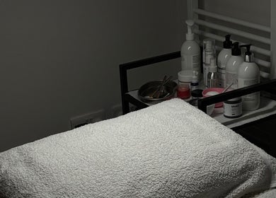 Calm treatment room at Laser Day Skin Clinic, Liversedge, England, GB, featuring soft towels and skincare products.