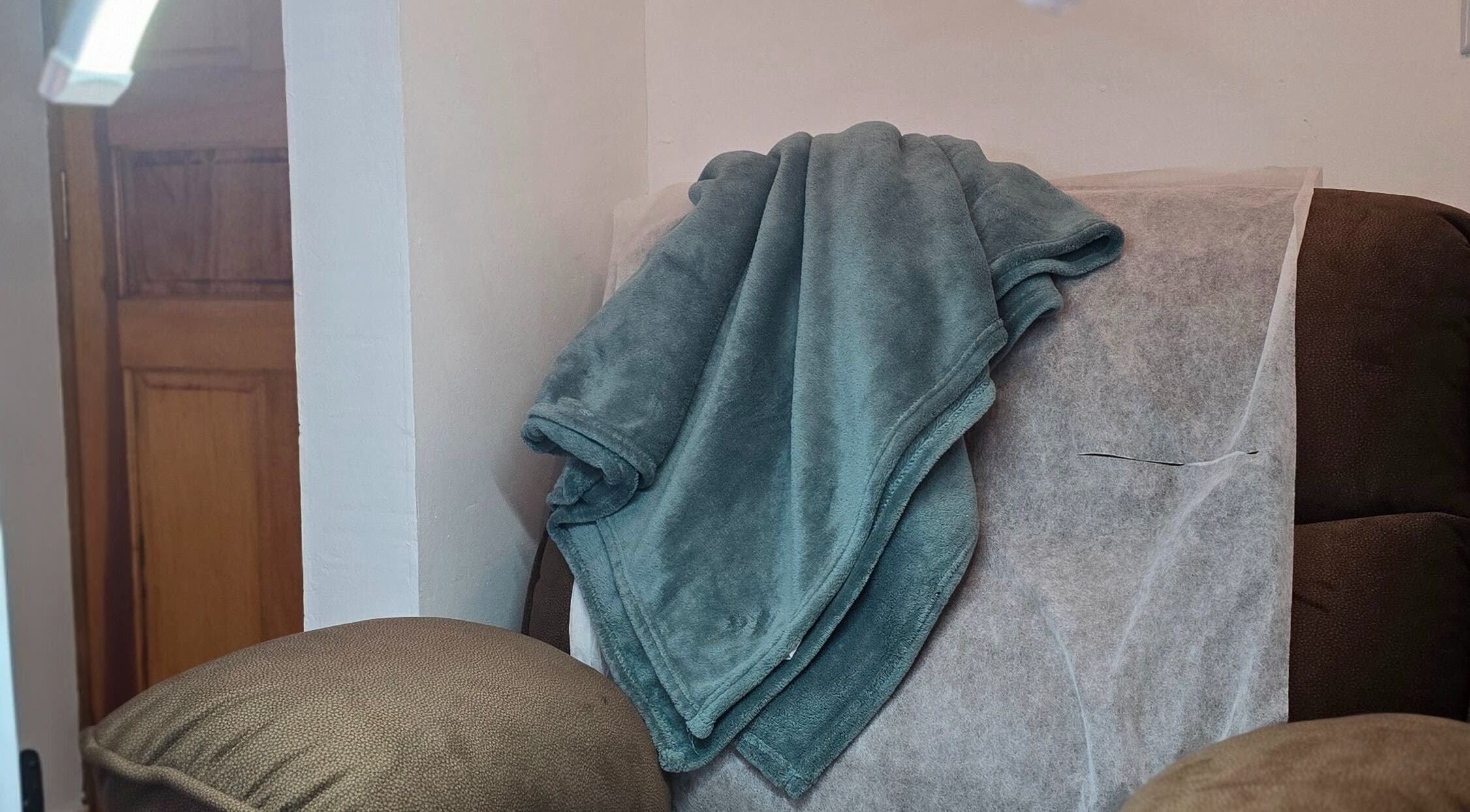 Cozy relaxation chair with a soft blanket at Nailée Maison Des Ongles, Victoria, SC.