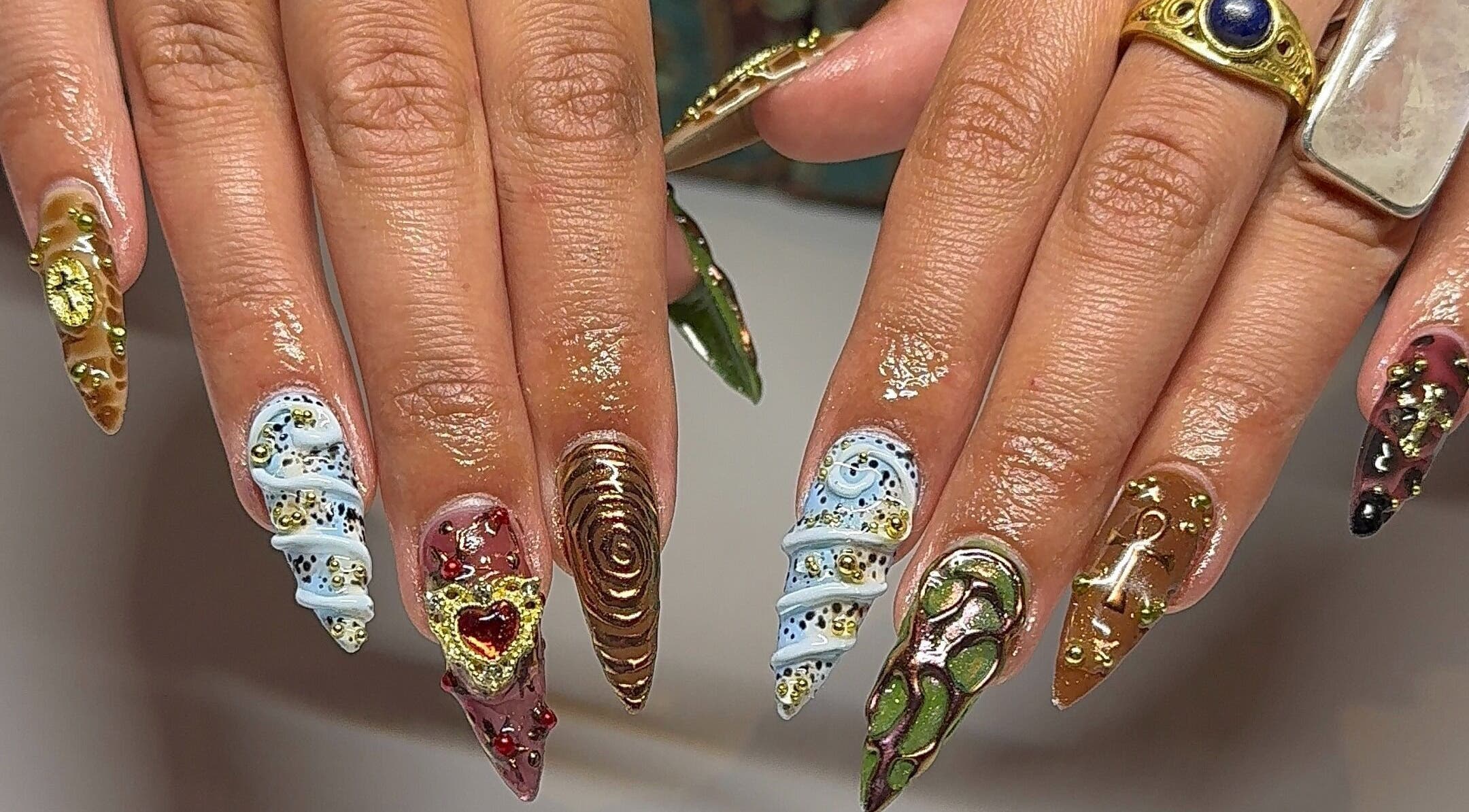 Intricate nail art with gold accents at Gelbyliv, Melbourne, Victoria, AU, showcasing unique designs.