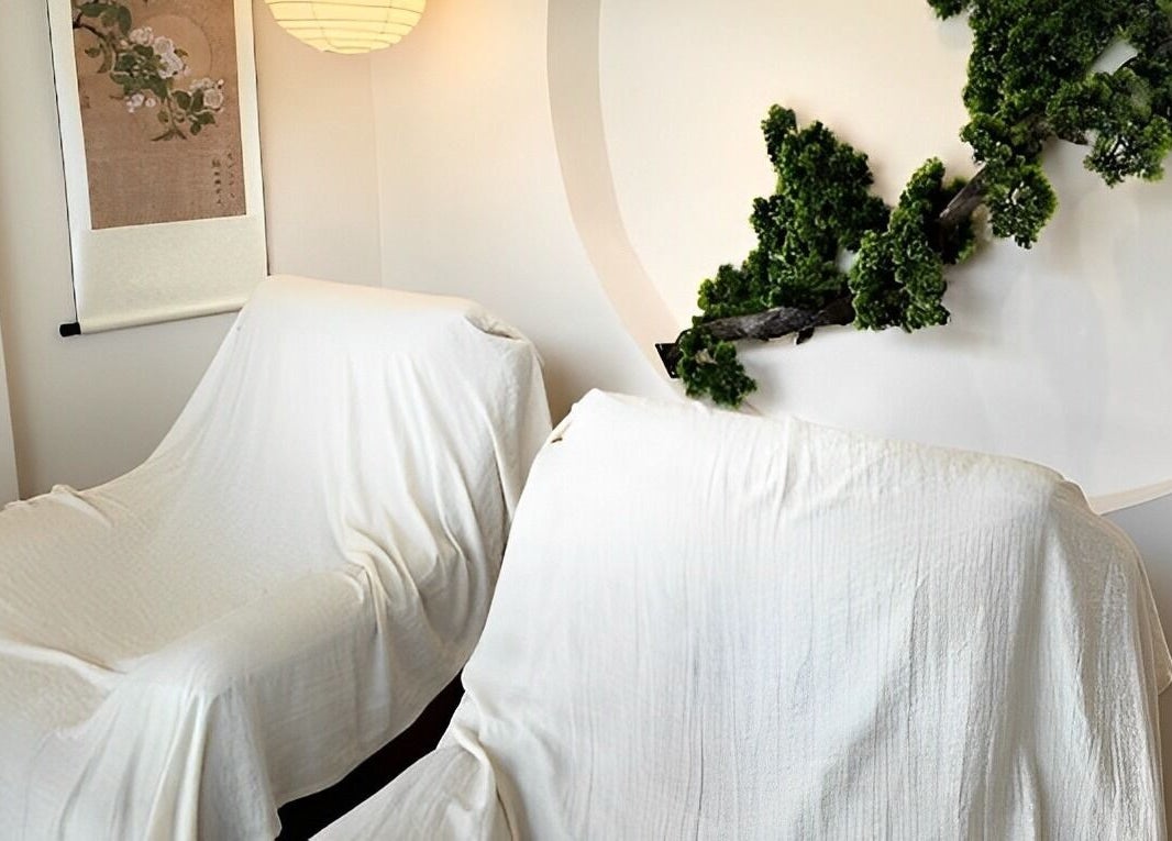 Relaxing spa chairs in tranquil setting at The Present Spa, Bali, Bali, ID, featuring elegant decor and greenery.