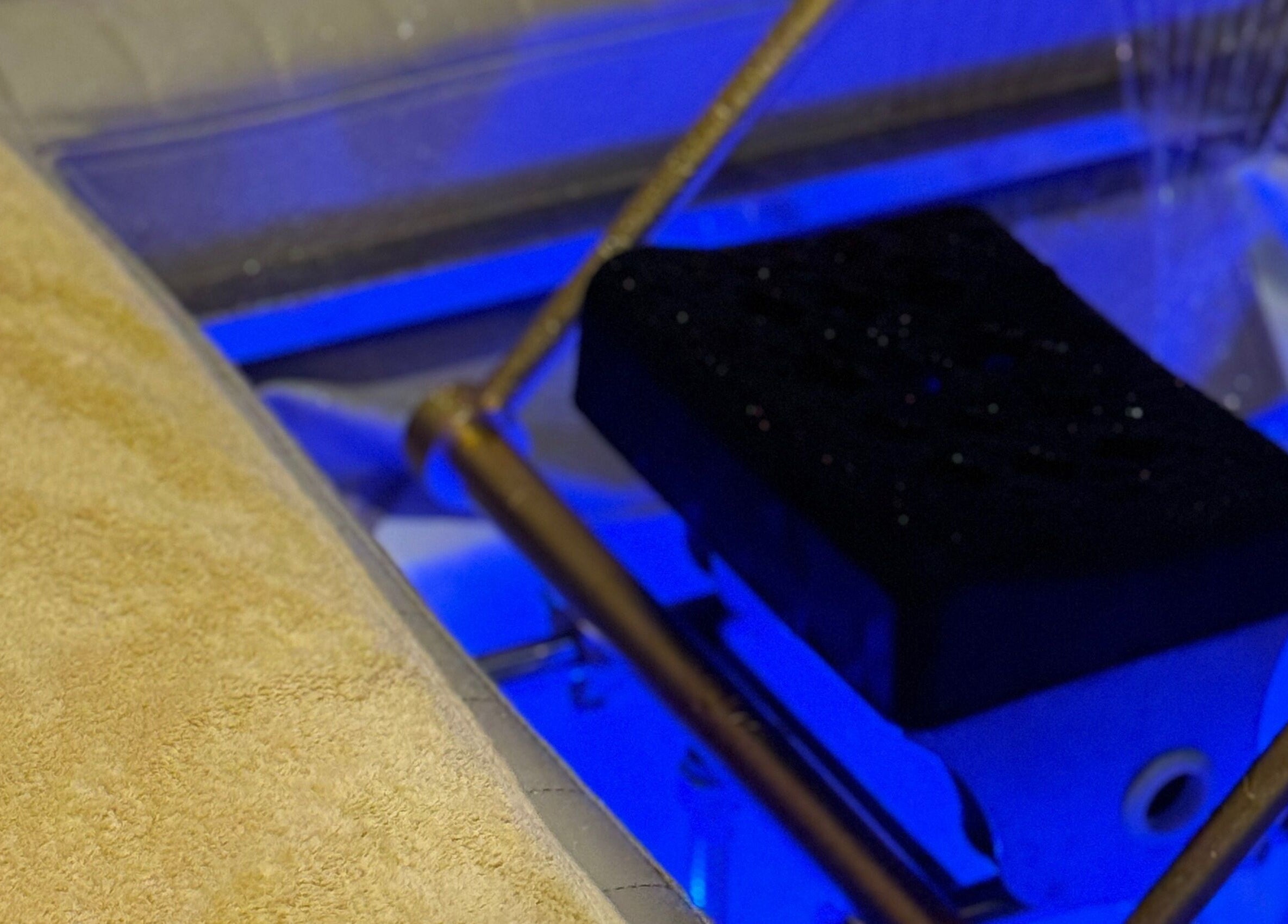 Comfortable spa bed at The Present Spa, Bali, Bali, ID, showcasing blue ambient lighting for a relaxing experience.