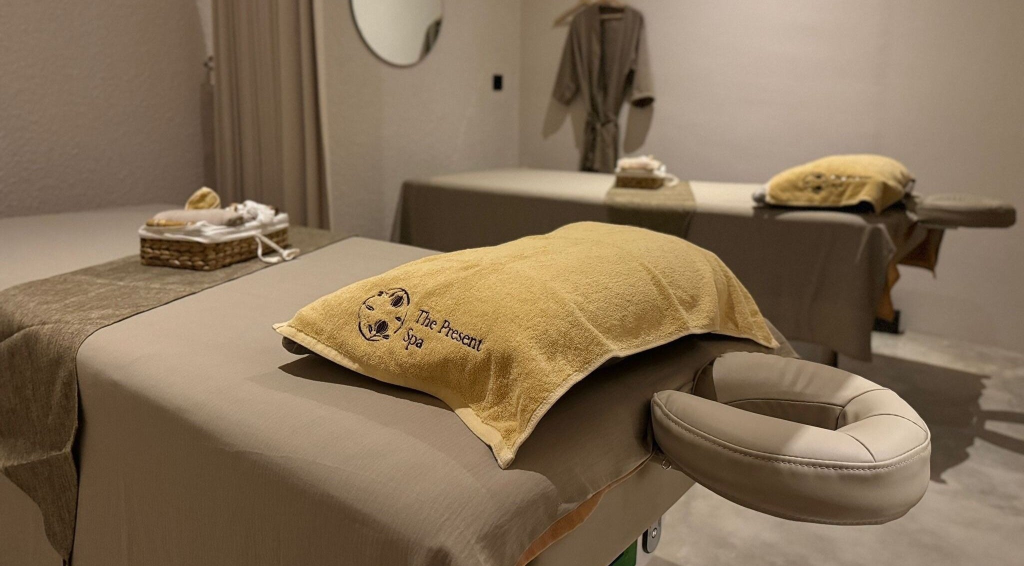 Tranquil massage room at The Present Spa, Bali, Bali, ID, showcasing elegant decor and plush treatment tables.