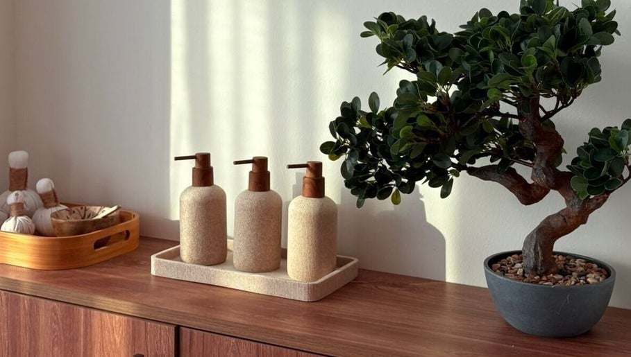 Elegant Zen decor at Kenko Japanese Hair Spa, Dubai, Dubai, AE featuring bonsai and natural dispensers.