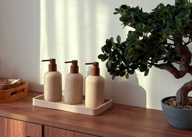 Elegant Zen decor at Kenko Japanese Hair Spa, Dubai, Dubai, AE featuring bonsai and natural dispensers.