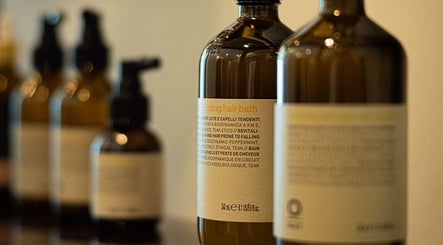 Hair spa products at Kenko Japanese Hair Spa, Dubai, Dubai, AE. Elegant bottles lined up for premium hair care.
