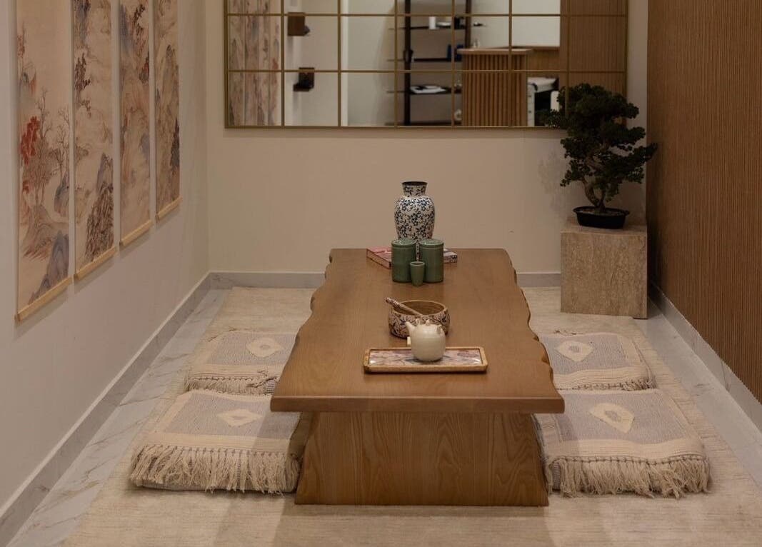 Elegant tea room at Kenko Spa, Dubai, Dubai, AE, showcasing a calming wooden table and artistic decor.
