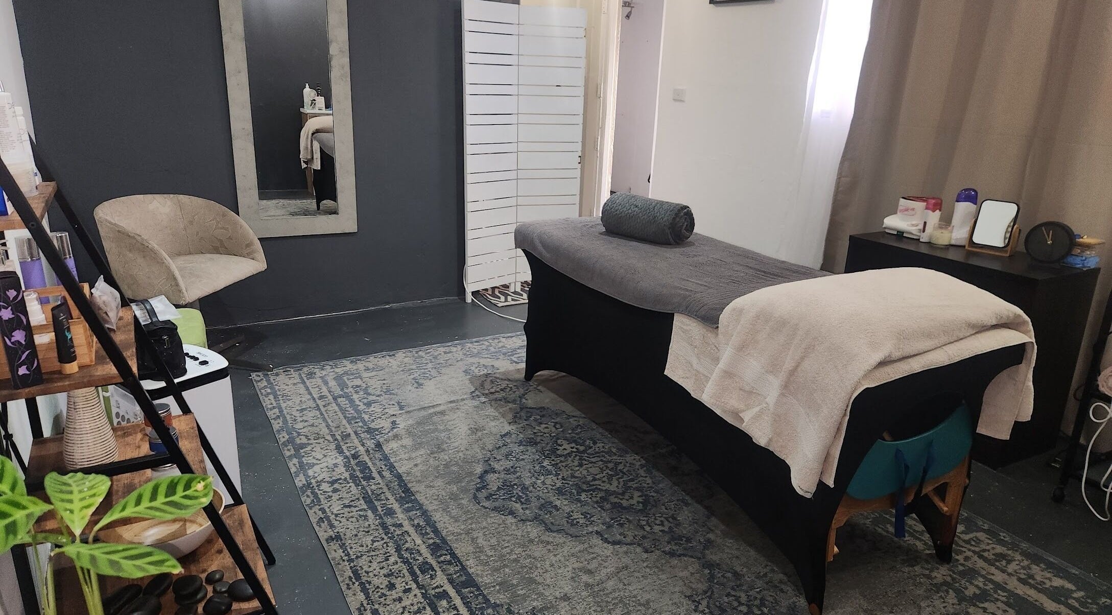 Massage room at Habitual Beauty, Cape Town, Western Cape, ZA, featuring a cozy massage table and calming decor.