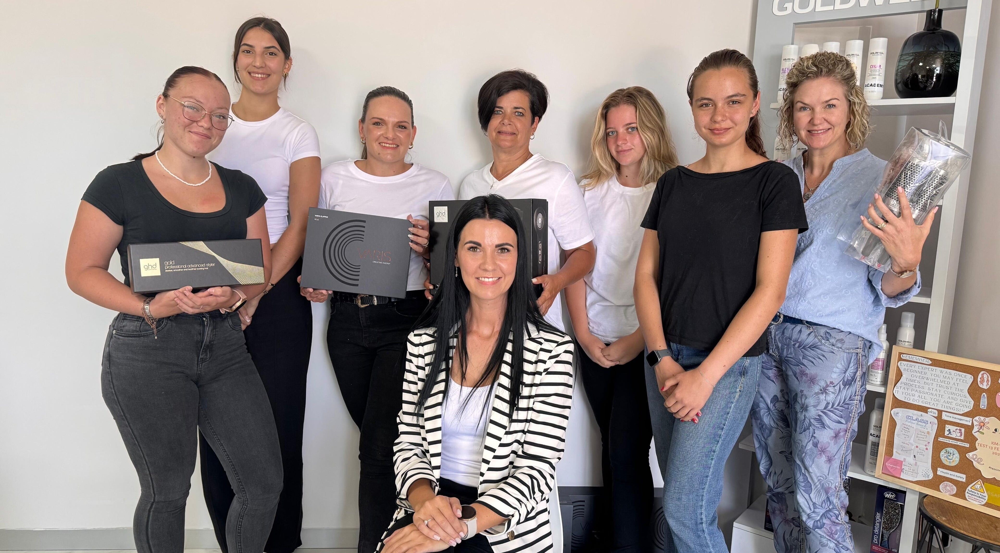 Hartenbos Hair Academy team posing with hair styling tools in Mossel Bay, Western Cape, ZA.