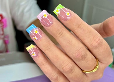 Colorful daisy nail art from The Witchery, Glasgow, Scotland, GB showcasing vibrant floral designs.