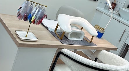 Modern nail station setup at SKR Beauty Bar, Broadbridge Heath, England, GB with colorful nail polish display.