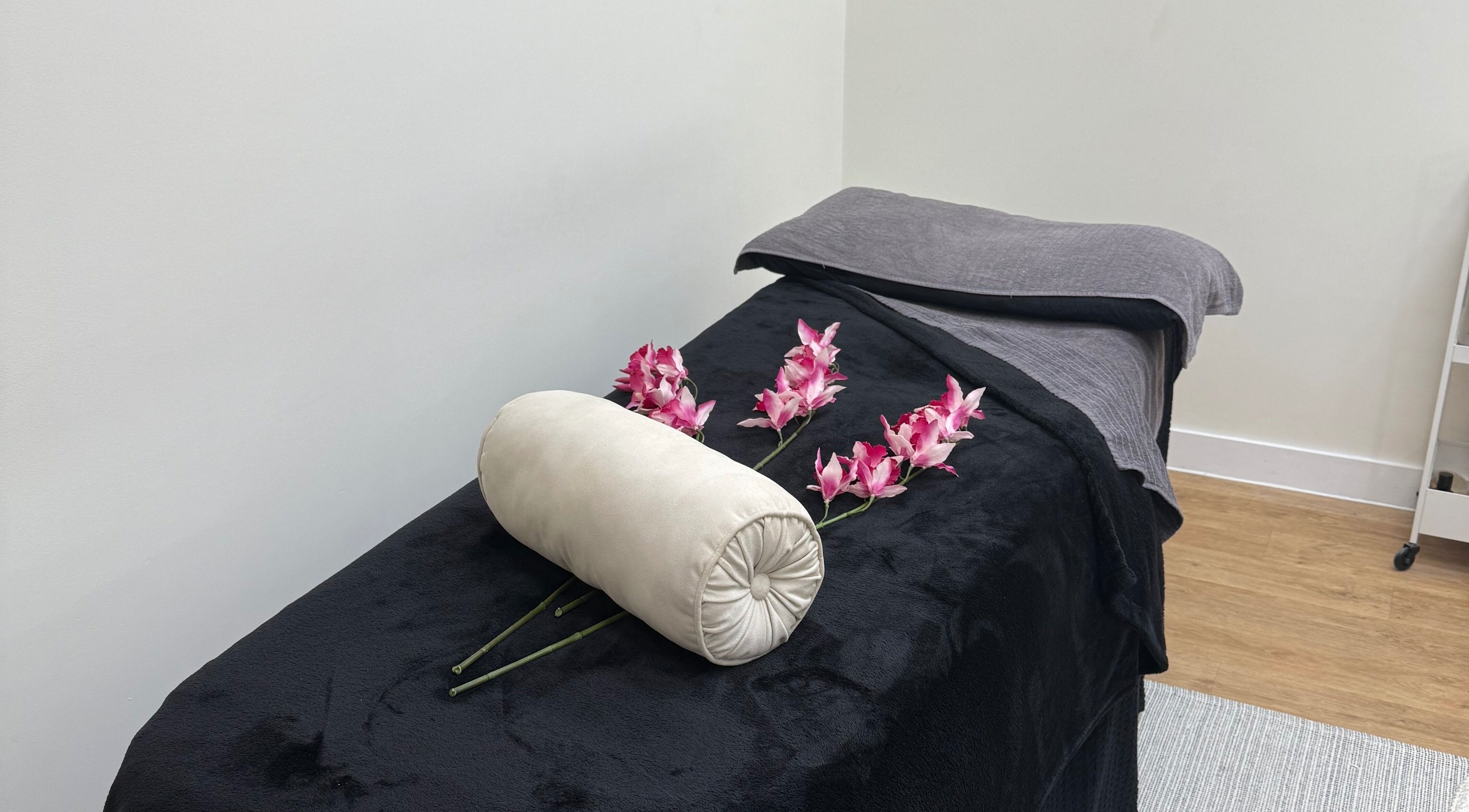 Luxurious massage table with orchids at SKR Beauty Bar, Broadbridge Heath, England, GB.