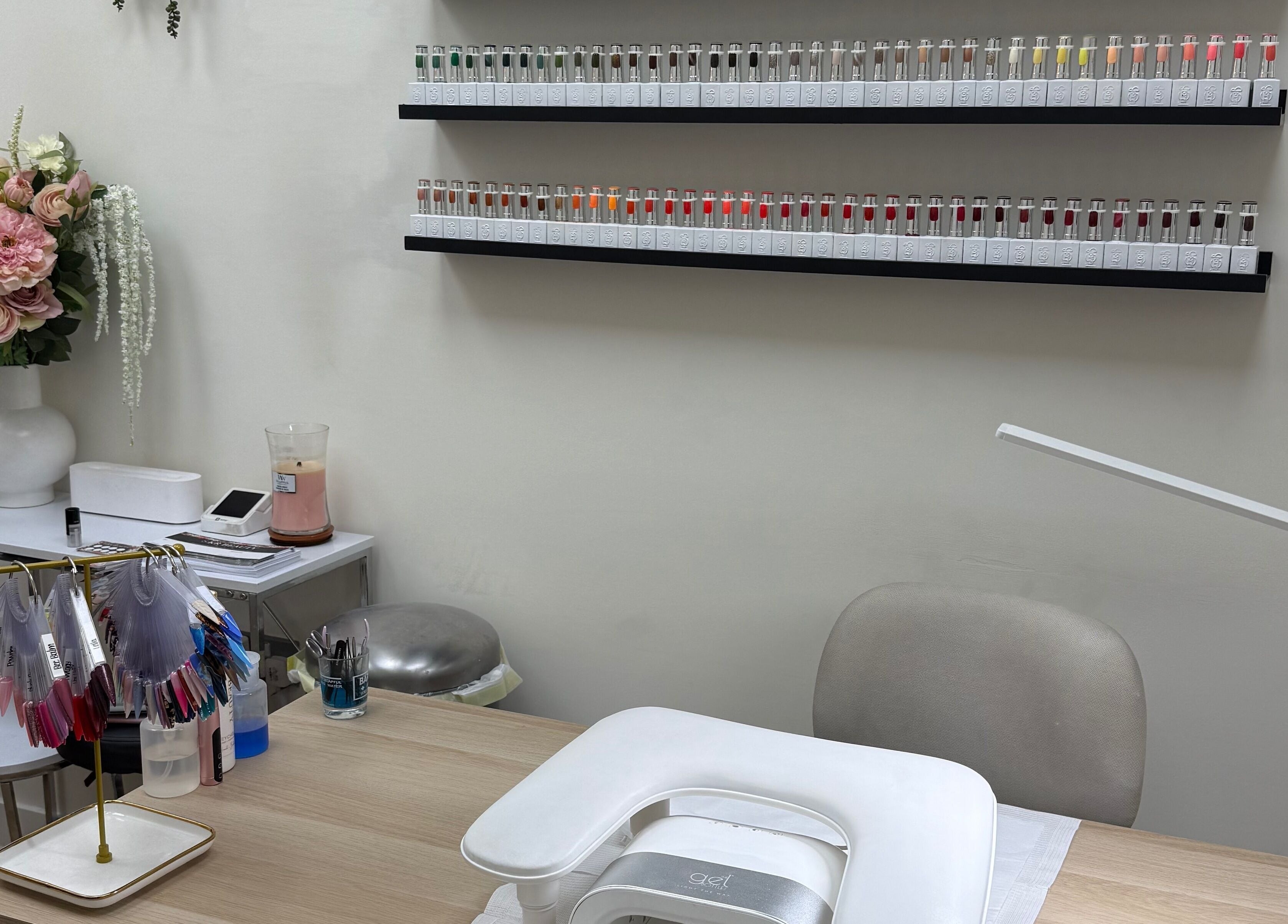 Nail service desk with vibrant polish selection at SKR Beauty Bar, Broadbridge Heath, England, GB.