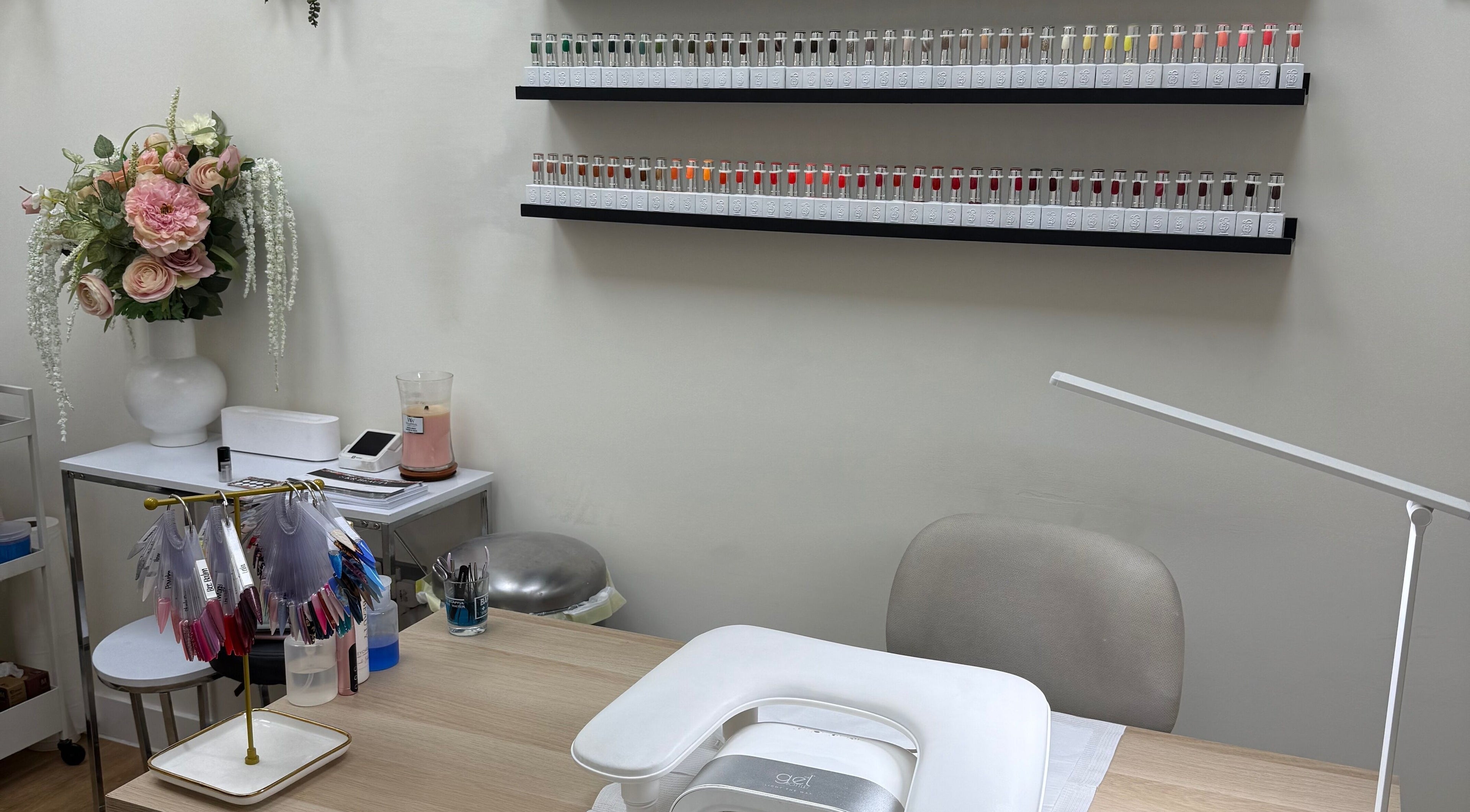 Nail service desk with vibrant polish selection at SKR Beauty Bar, Broadbridge Heath, England, GB.