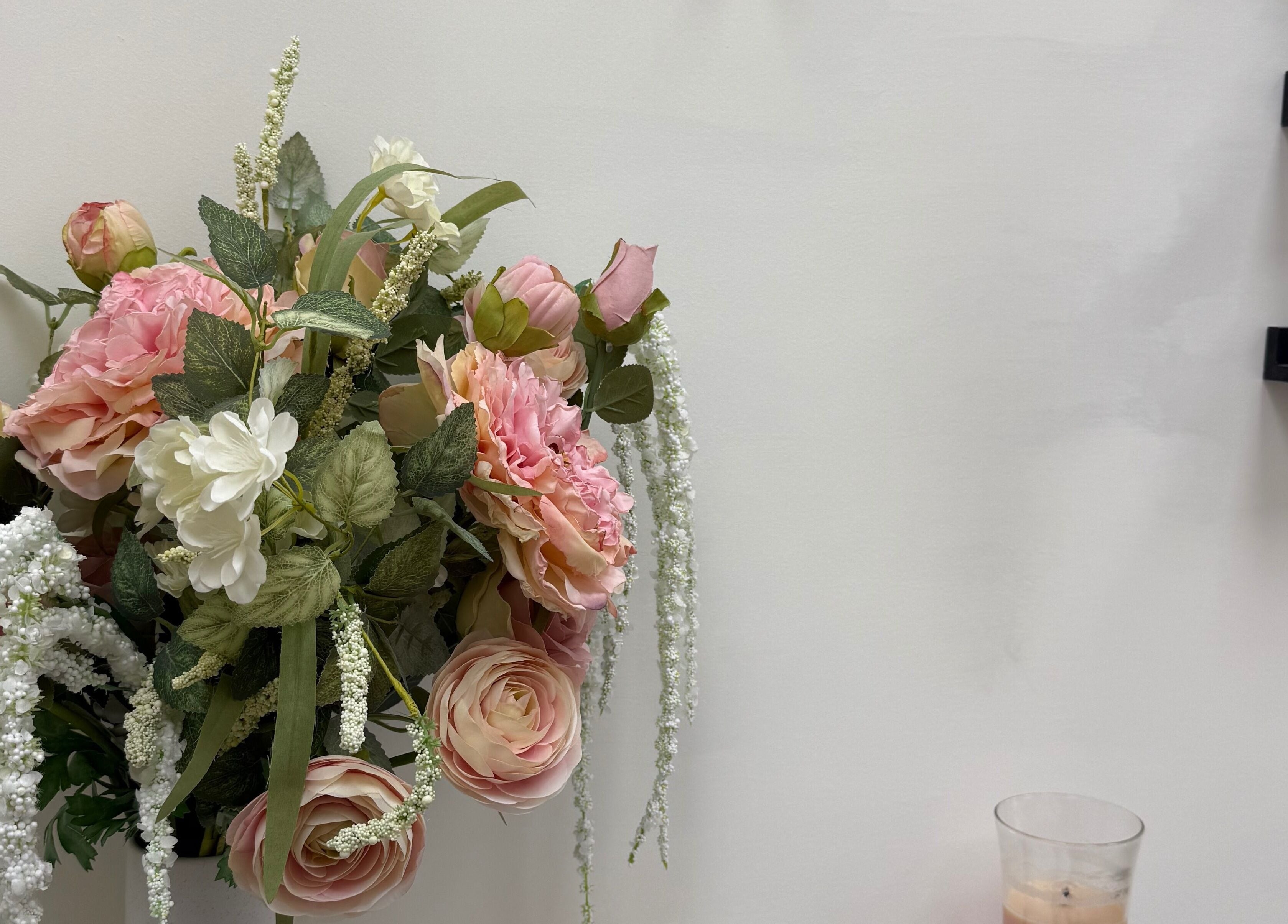 Elegant floral arrangement at SKR Beauty Bar, Broadbridge Heath, England, GB showcasing beauty products.
