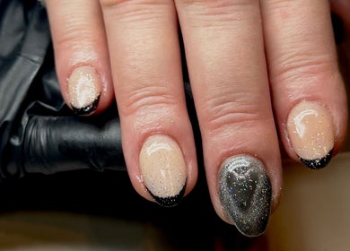 Elegant glitter nails at Lvy Luxe Nails, Swindon, England, GB. Black tips and shimmering silver accent.