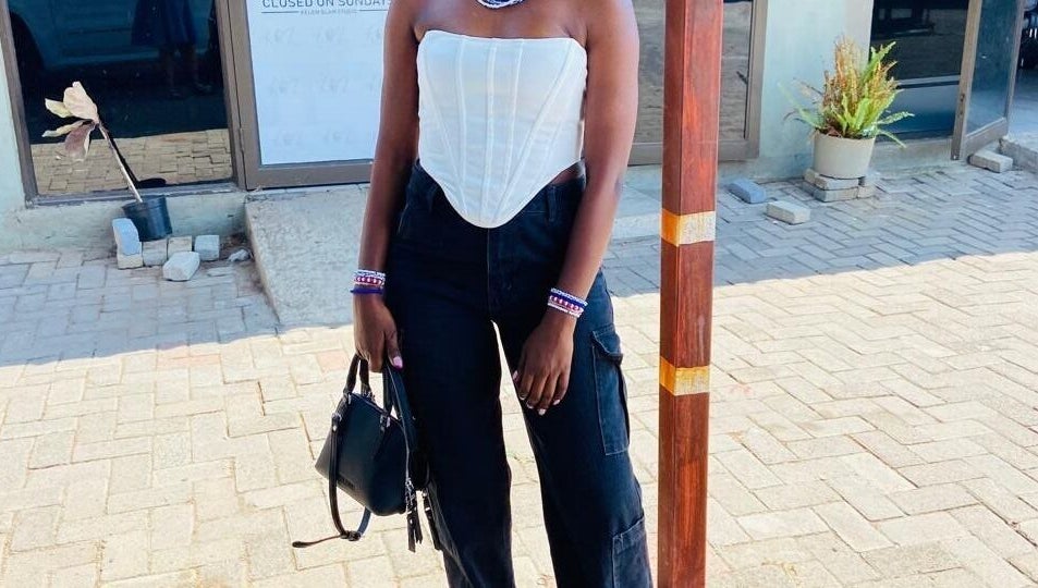 Stylish individual outside Polished_by_mini in Rustenburg, North West, ZA, showcasing modern fashion.