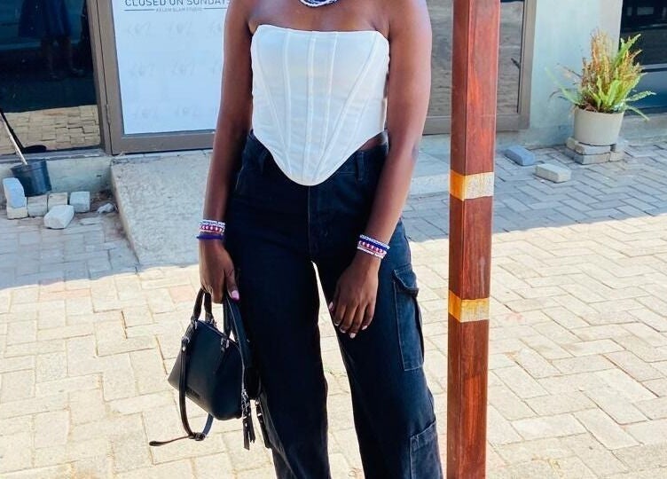 Stylish individual outside Polished_by_mini in Rustenburg, North West, ZA, showcasing modern fashion.