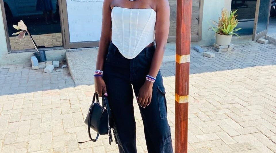 Stylish individual outside Polished_by_mini in Rustenburg, North West, ZA, showcasing modern fashion.