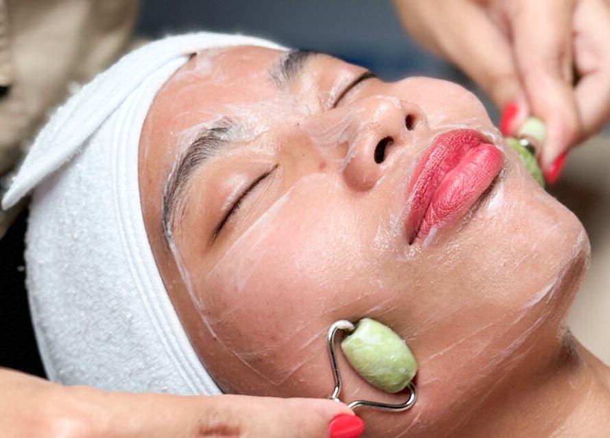 Facial massage at Mandala Skin by Claudia, Macleay Island, Queensland, AU, using jade rollers for relaxation.