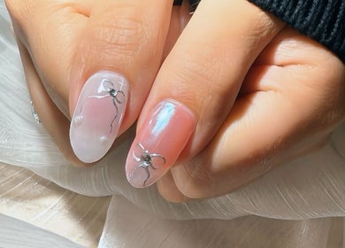 Close-up of elegant nail art with bows at Qlean Nails, Singapore, Singapore, SG.