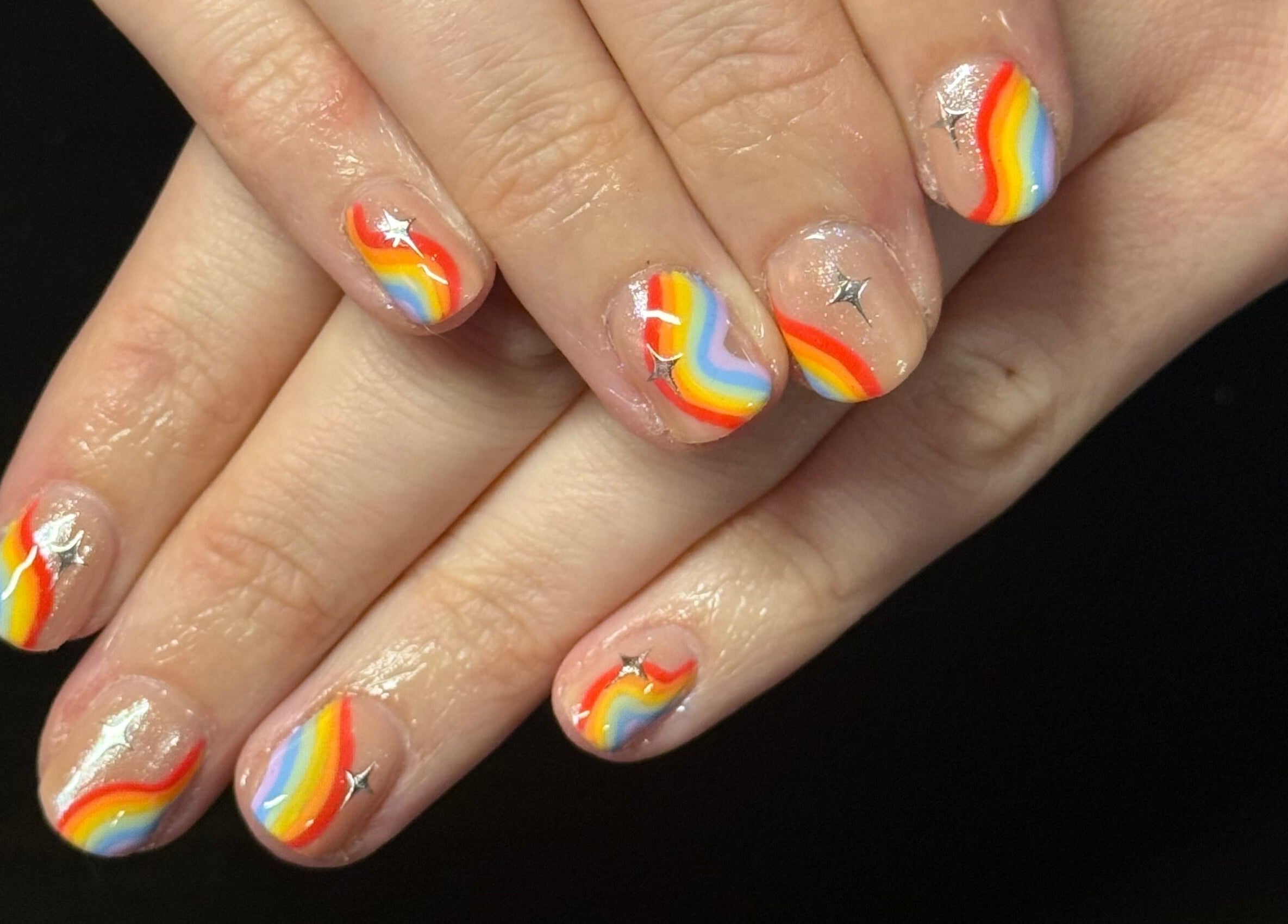 Colorful rainbow nail art at Opal & Claws in Hurst, Texas, US. Perfect for adding a vibrant touch to your look.