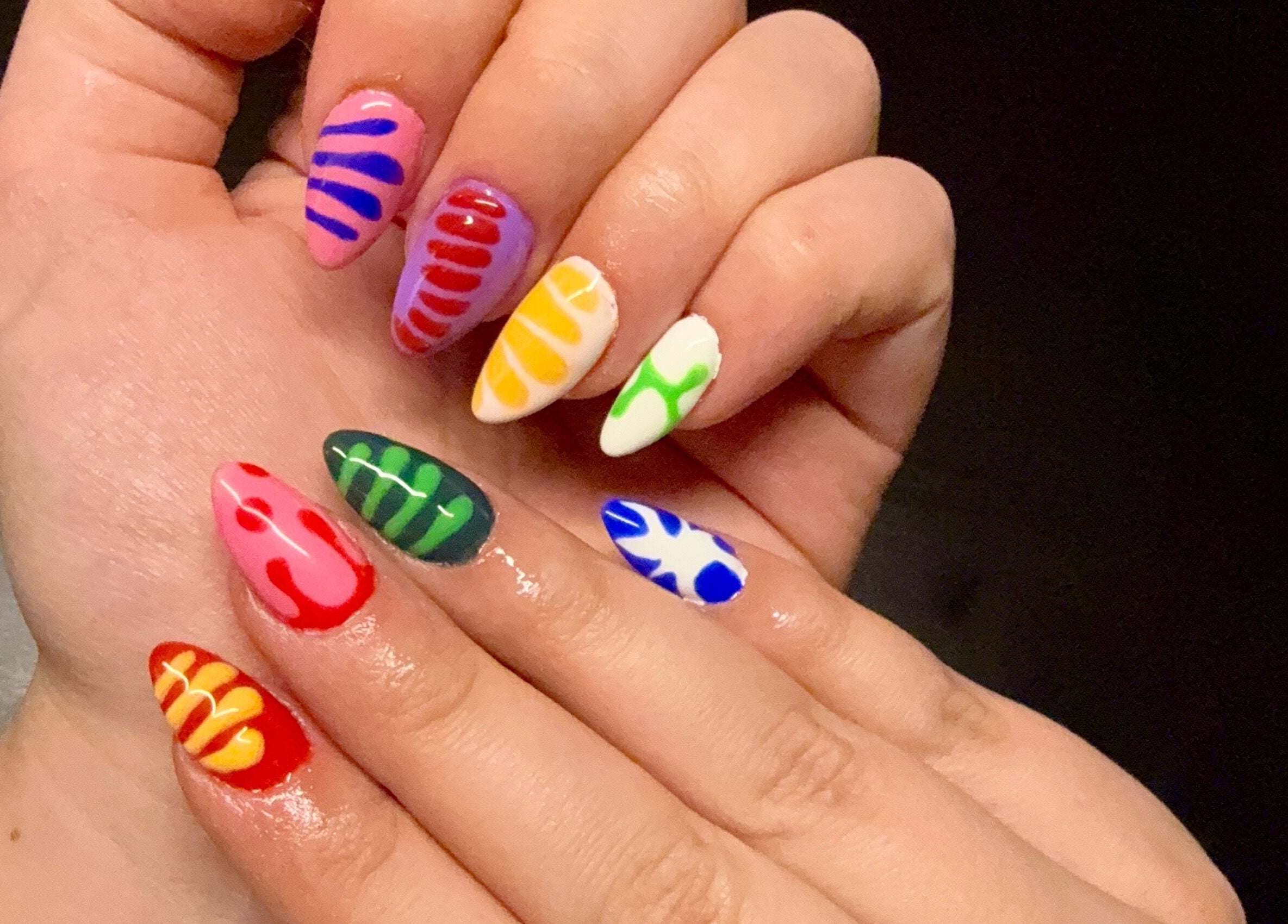 Colorful nail art design at Opal & Claws, Hurst, Texas, US showcasing vibrant patterns.