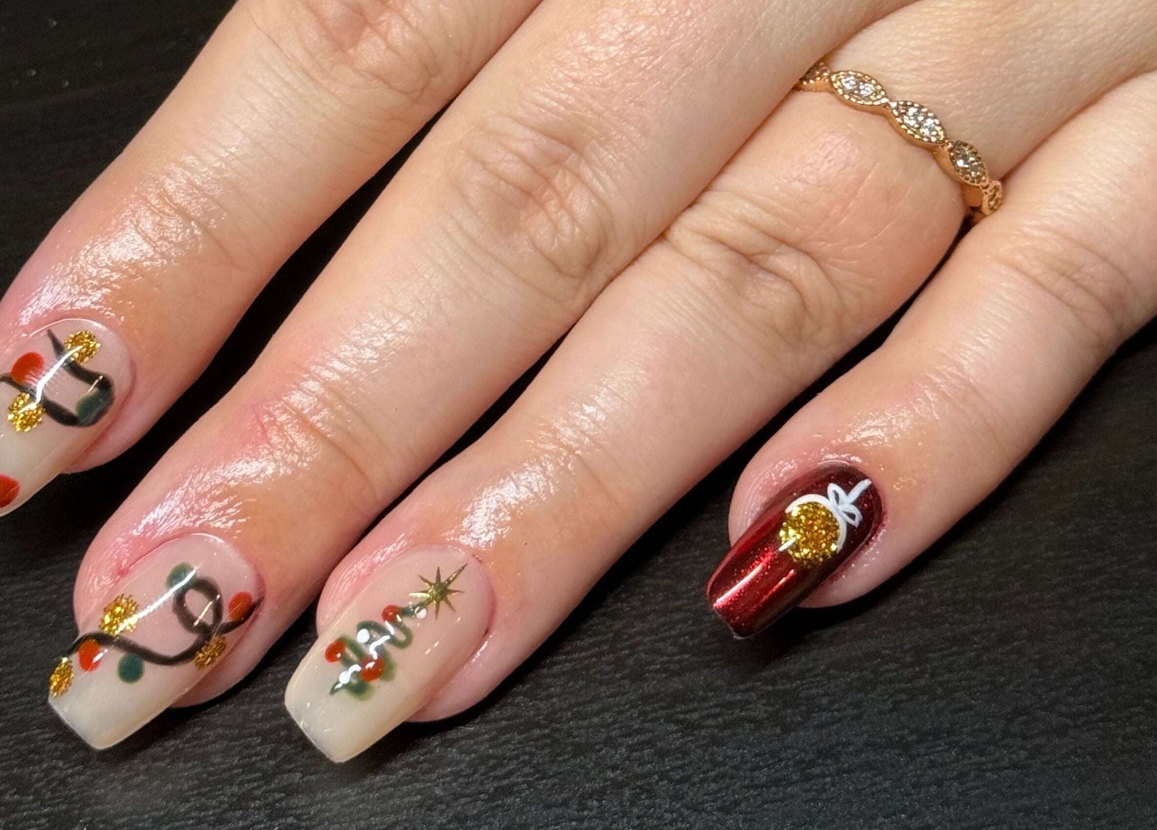 Festive nail art at Opal & Claws in Hurst, Texas, US showcasing holiday-themed designs.
