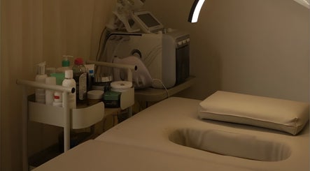 Relaxing treatment room at 8 Infiito Salon, Jeddah, Makkah Province, SA with skincare products and massage bed.