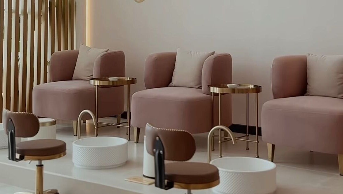 Chic pedicure lounge at Glowing Beauty & Spa, Al Athaiba, Muscat Governorate, OM, featuring plush seating.